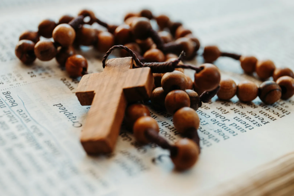 beaded brown rosary on open bible